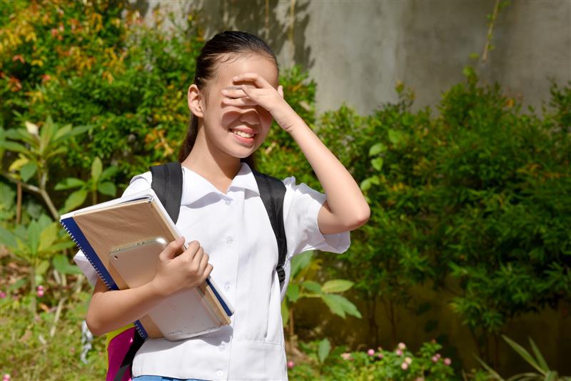 school kid sweating in the heat and sun